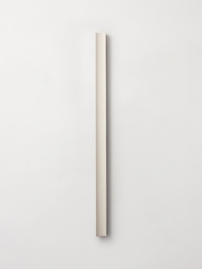 a long piece of wood on a white wall.