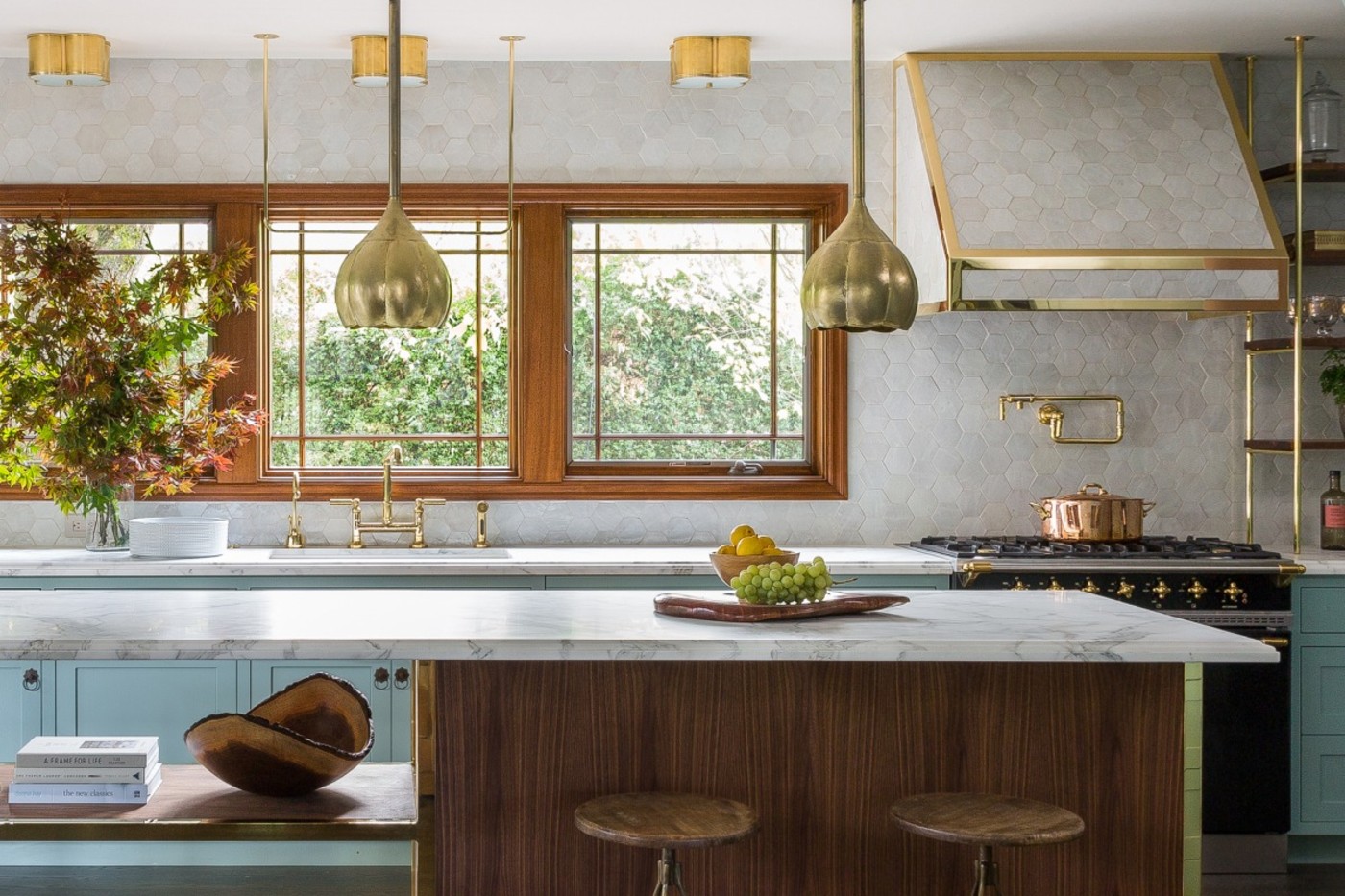 a kitchen with blue cabinets and gold accents.