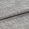 Woven grey curtain fabric folded into overlapping horizontal layers, showing coarse, irregular weave; tight close-up with neutral lighting highlighting texture and subtle tonal variation.