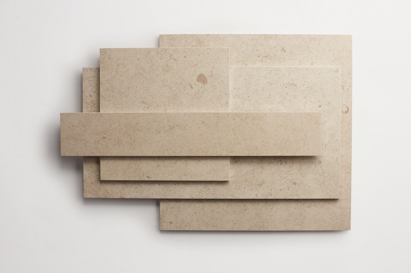 a set of beige tiles on a white surface.