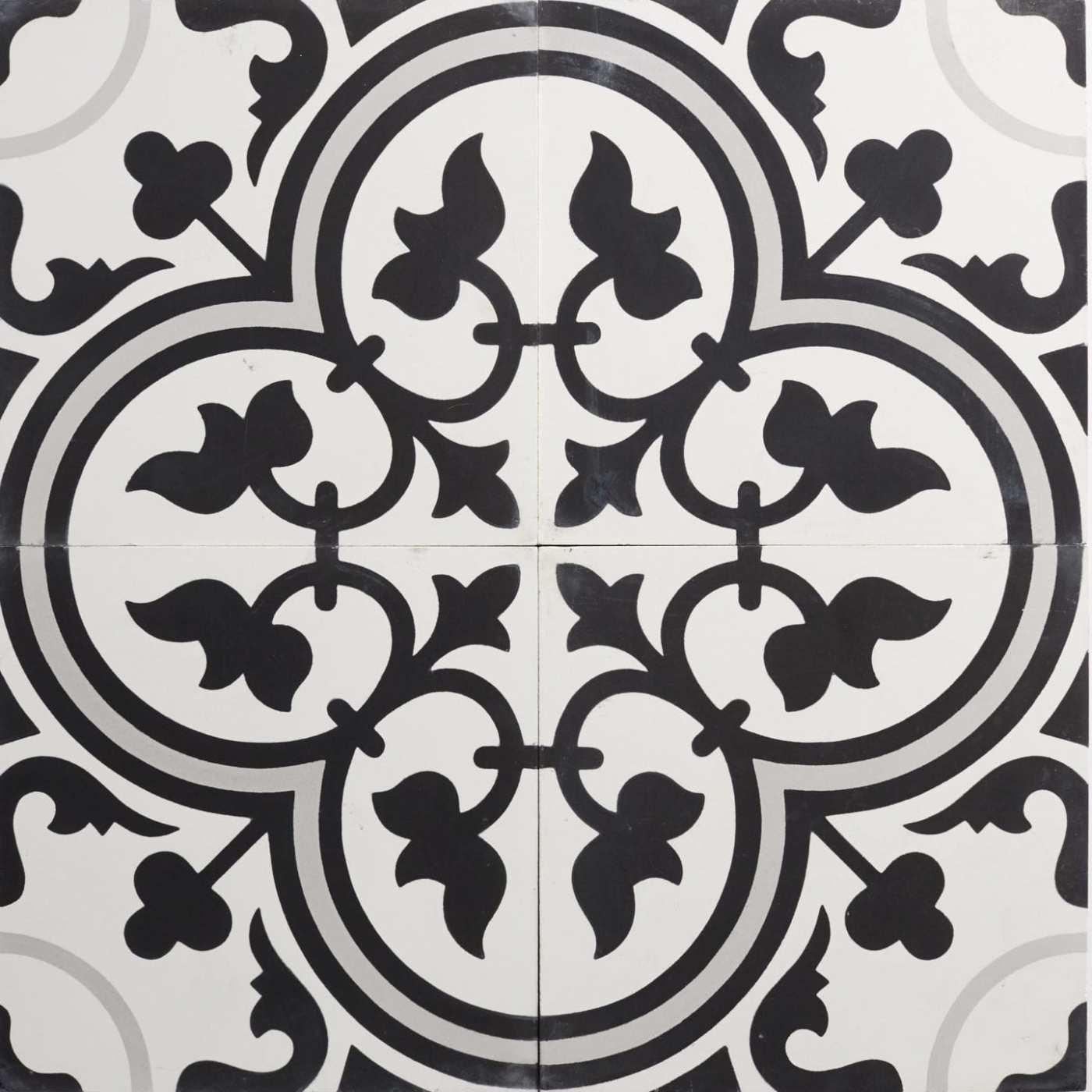 four black and white tiles with ornate designs.
