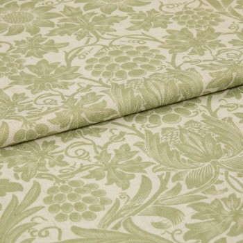 Green-and-cream floral-patterned fabric, folded with an overlapping edge, displaying woven texture and grape-and-leaf motifs; close-up studio shot with soft, even lighting suggesting an upholstery or curtain sample.