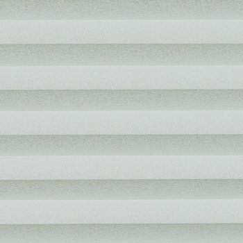 Cellular pleated blinds, fully lowered with evenly spaced pale gray-green horizontal bands, filtering diffuse daylight across a neutral interior and creating soft, uniform illumination.