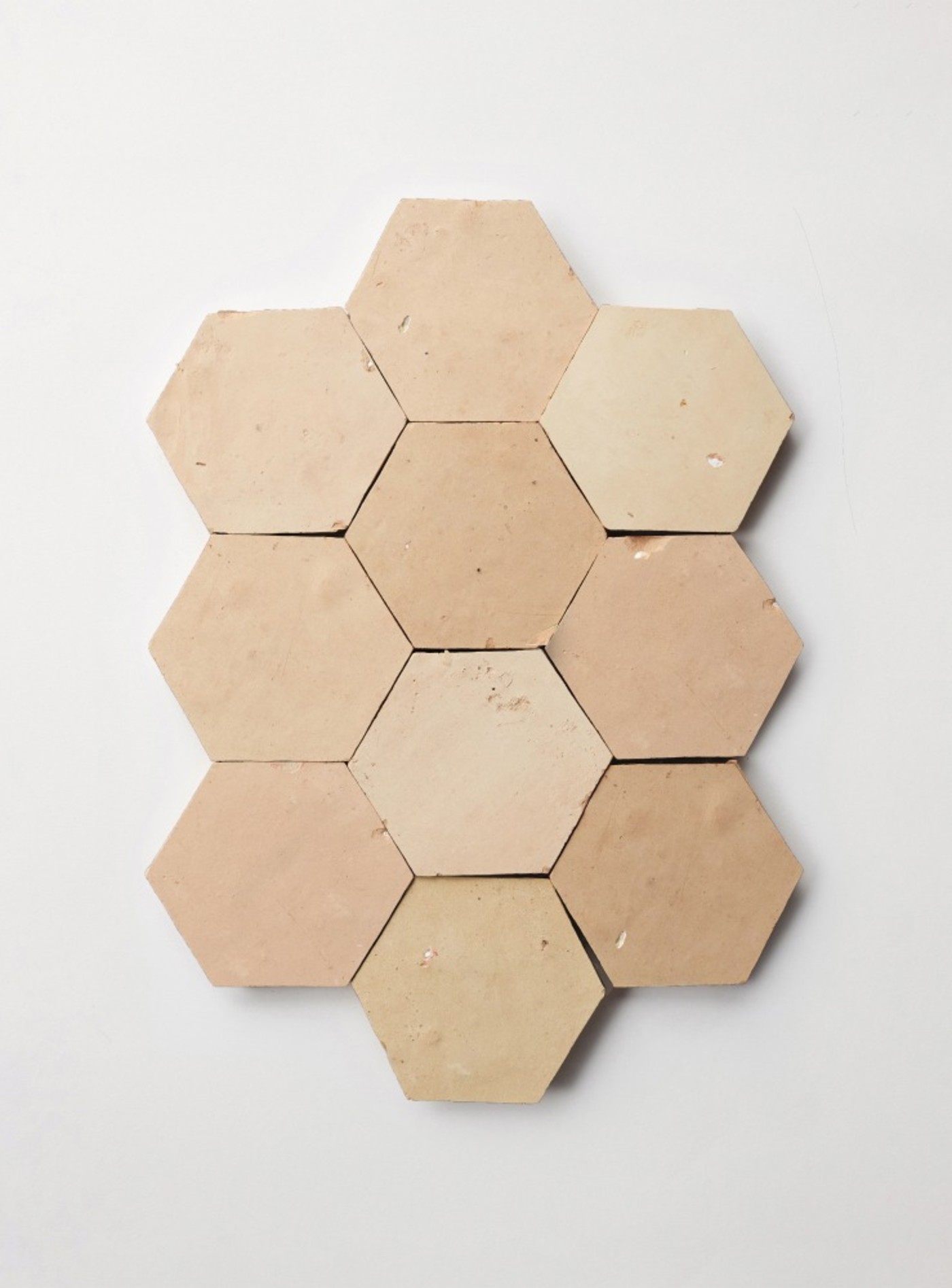 a set of beige hexagon tiles on a white background.