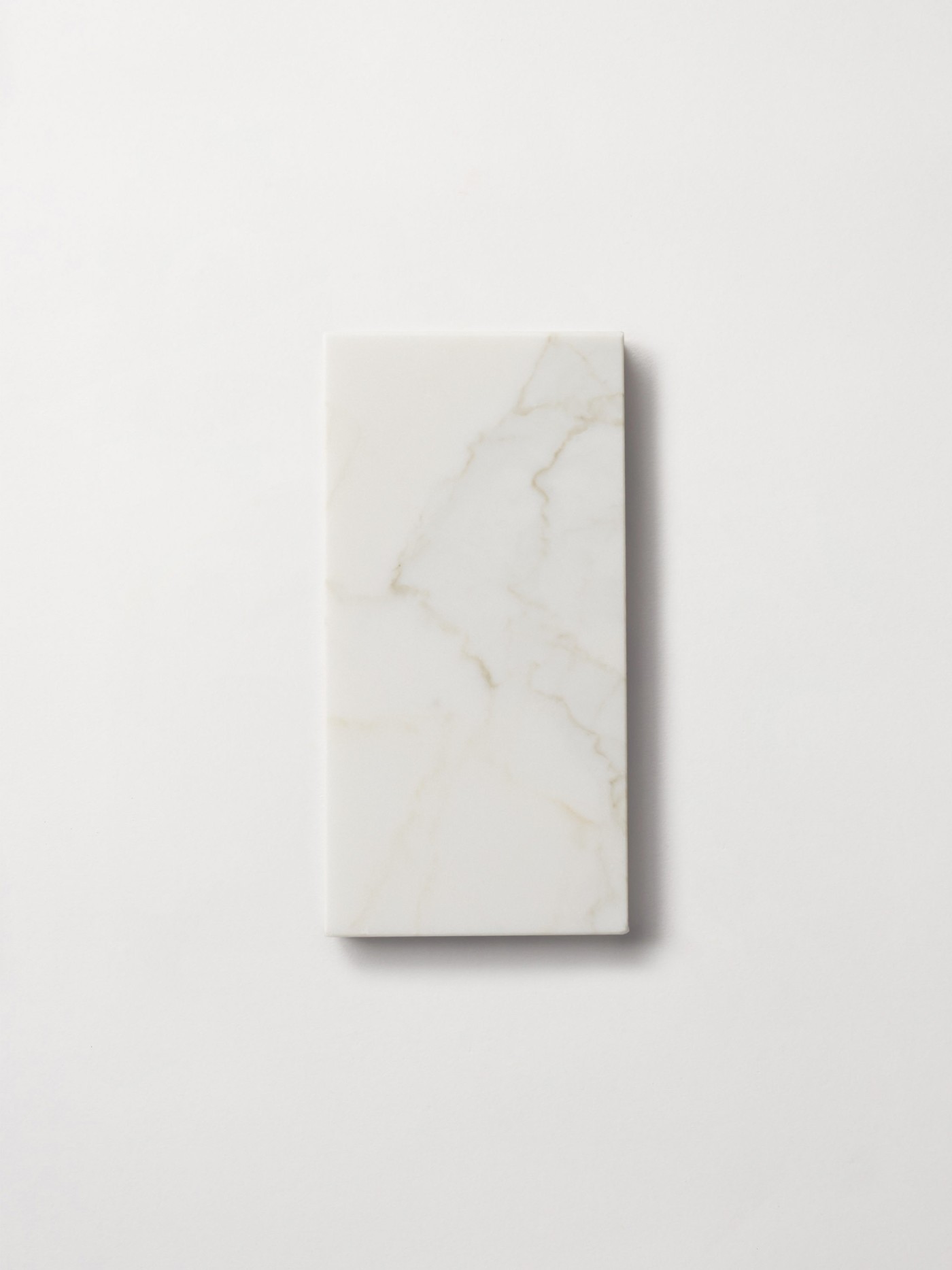 a white marble rectangle on a white surface.