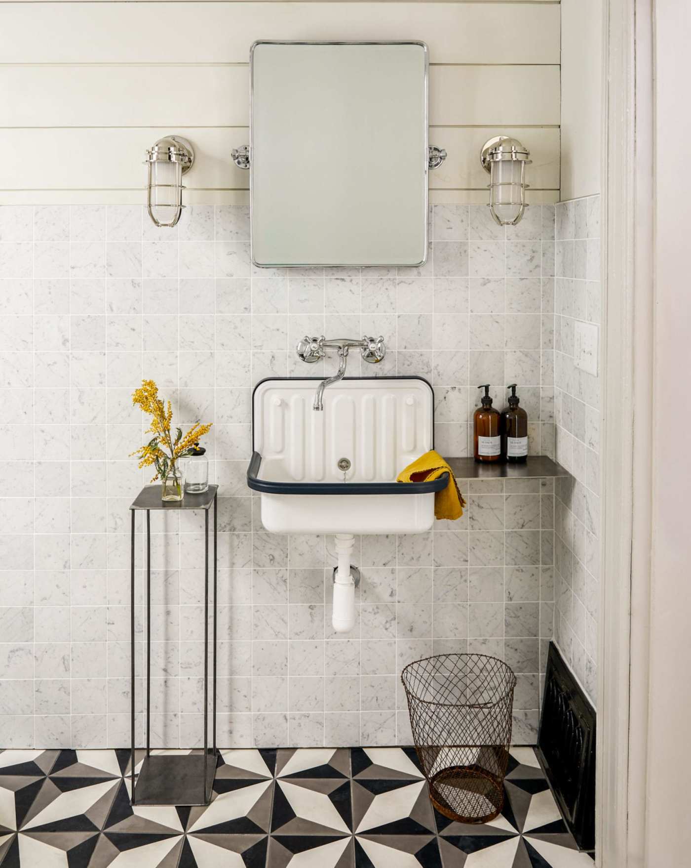 a bathroom with a black and white tiled floor.