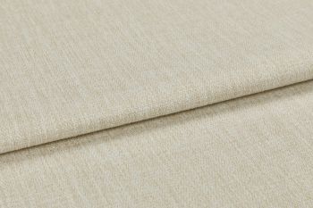 Beige woven upholstery fabric (window dressing absent), folded once with an overlapping edge; close-up shows textured, slightly nubby weave under neutral studio lighting on a flat surface.