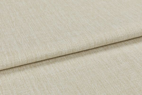 Beige woven upholstery fabric (window dressing absent), folded once with an overlapping edge; close-up shows textured, slightly nubby weave under neutral studio lighting on a flat surface.