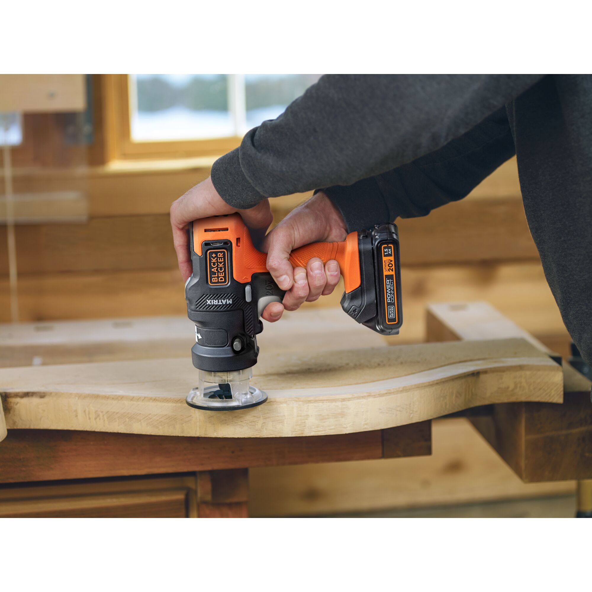 Person using maxtrix router attachment on a piece of wood