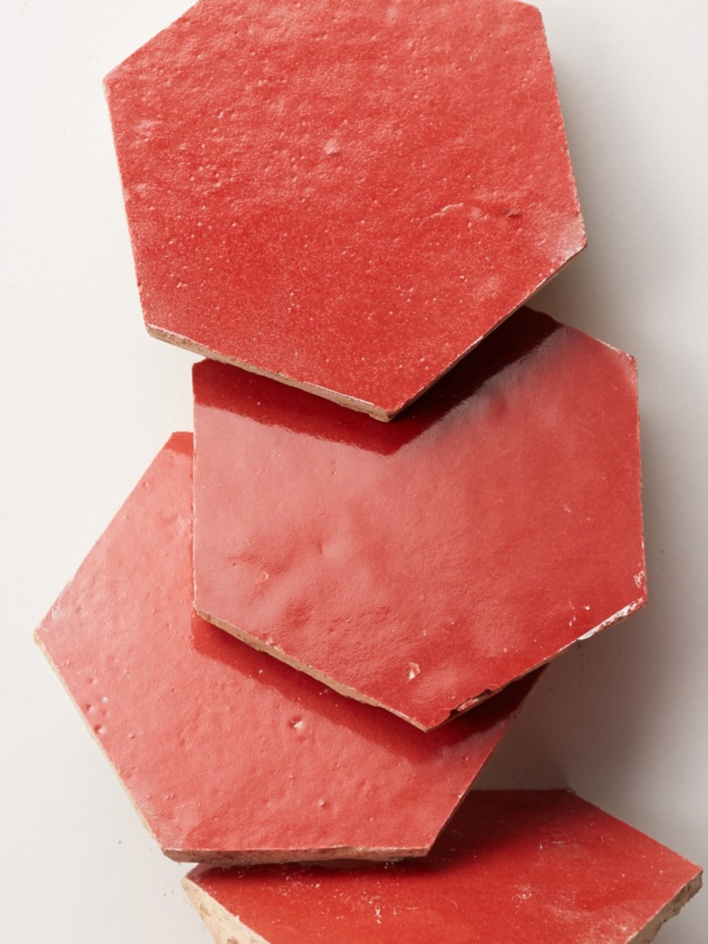 a stack of red tiles on a white surface.