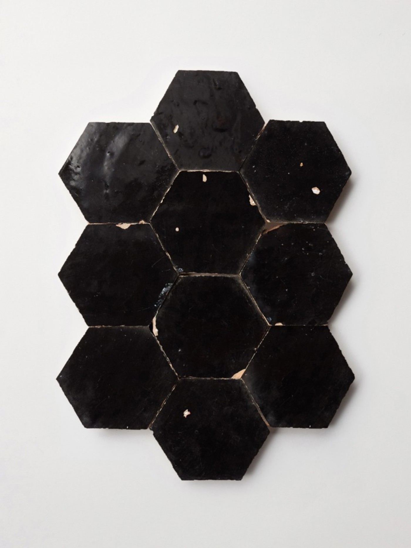 black hexagon tiles on a white surface.