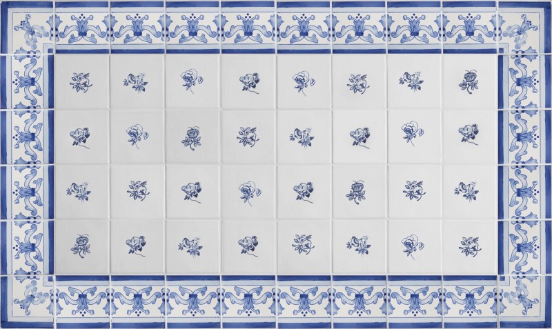 some blue and white tiles with floral designs arranged into a pattern.