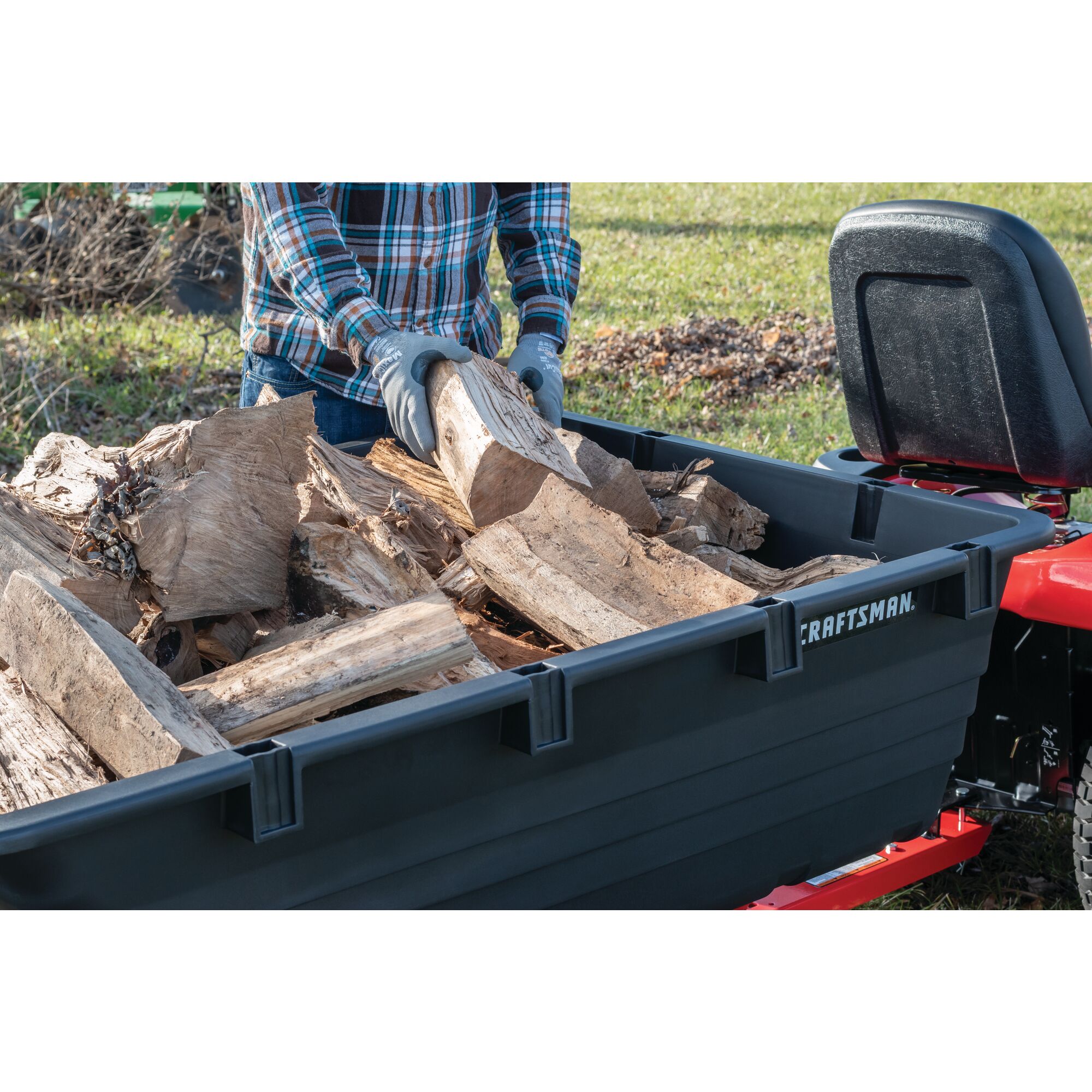 17 cubic foot poly cart being used to load wooden logs.