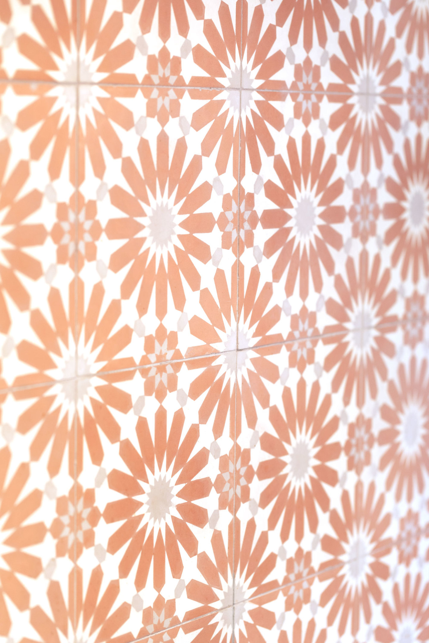 a close up of an orange and white tiled wall.