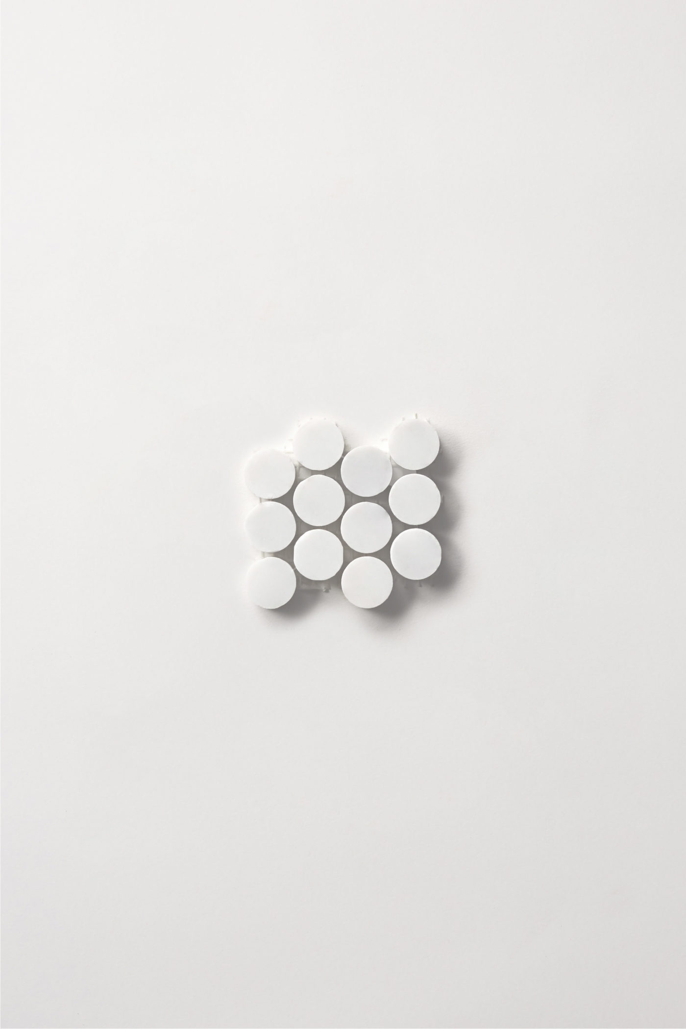 a small white penny round tile sheet on a white background.