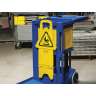 Rubbermaid Commercial, Multilingual "Caution" Stable, Floor Sign, Yellow, 26"