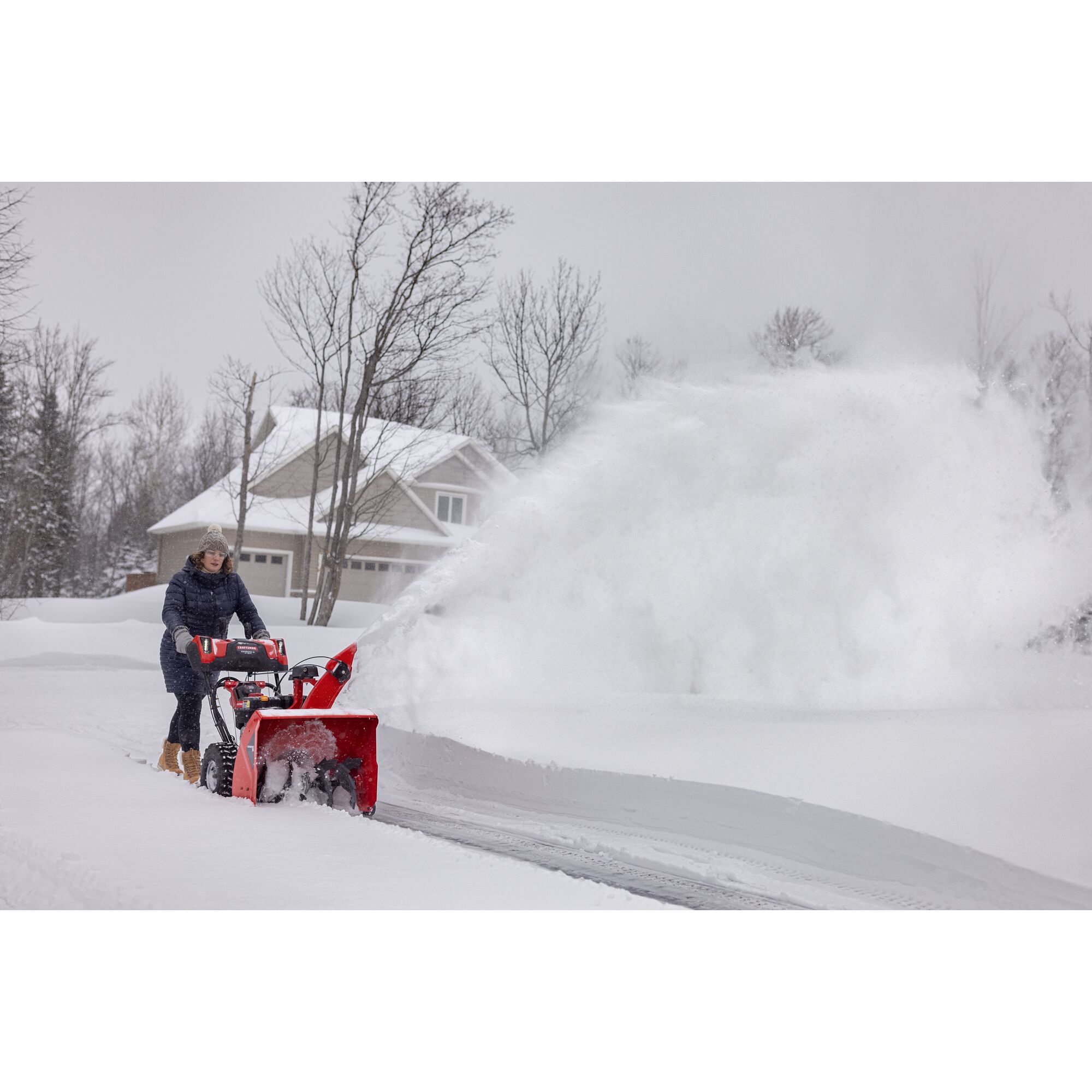 CRAFTSMAN Performance 26 V20 Start Snowblower clearing snow off driveway house in background