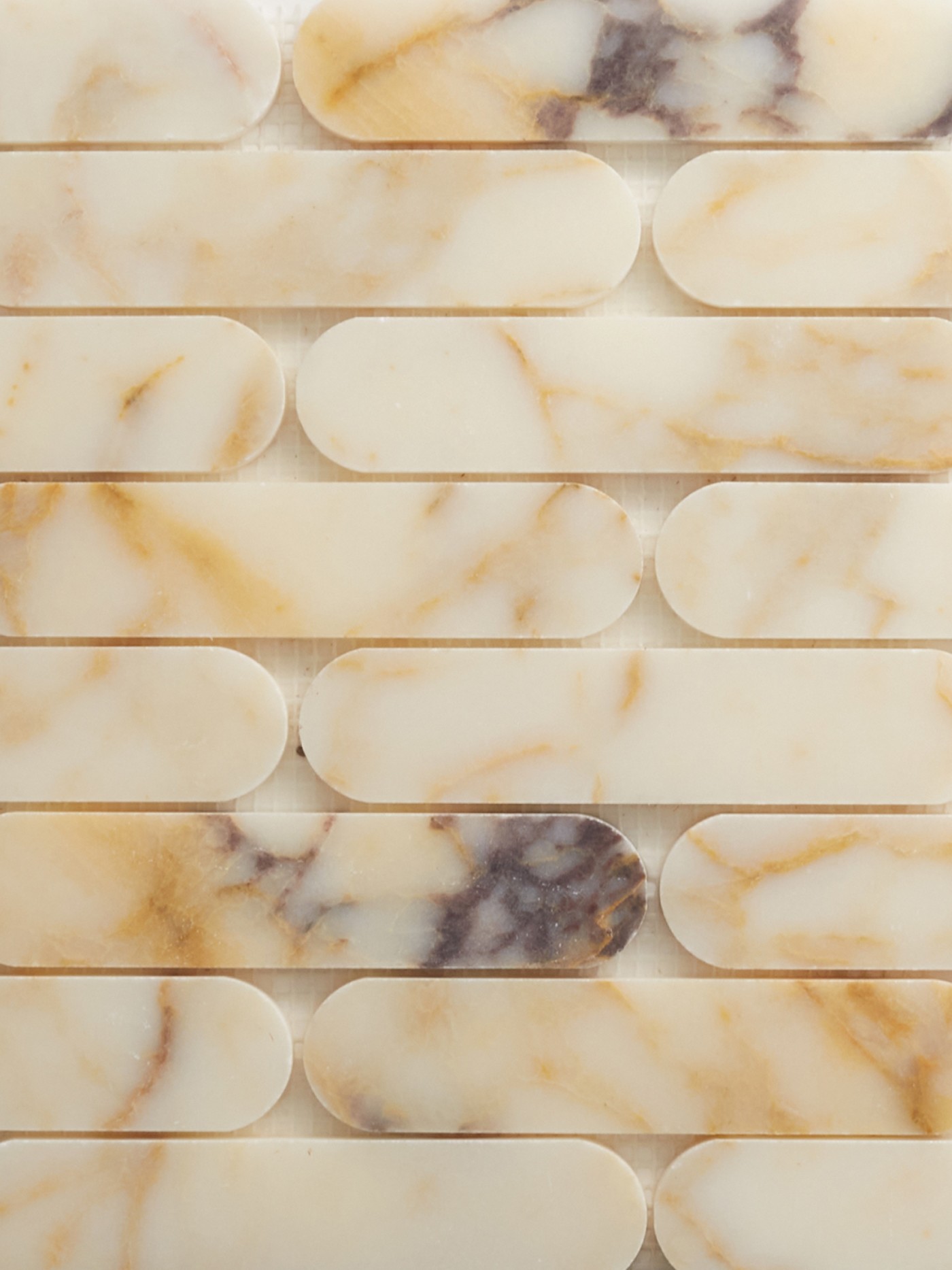 a close up of white and brown marble tiles.