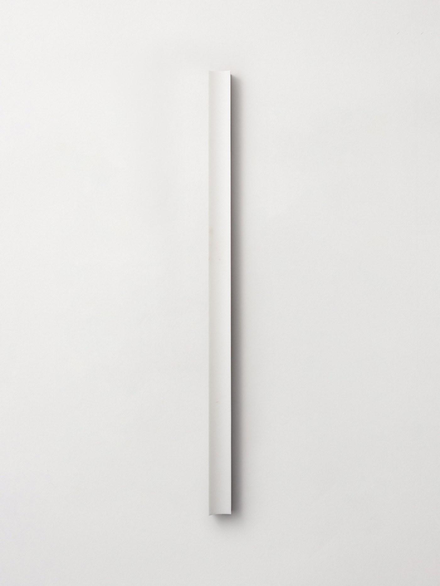 a white piece of wood on a white wall.