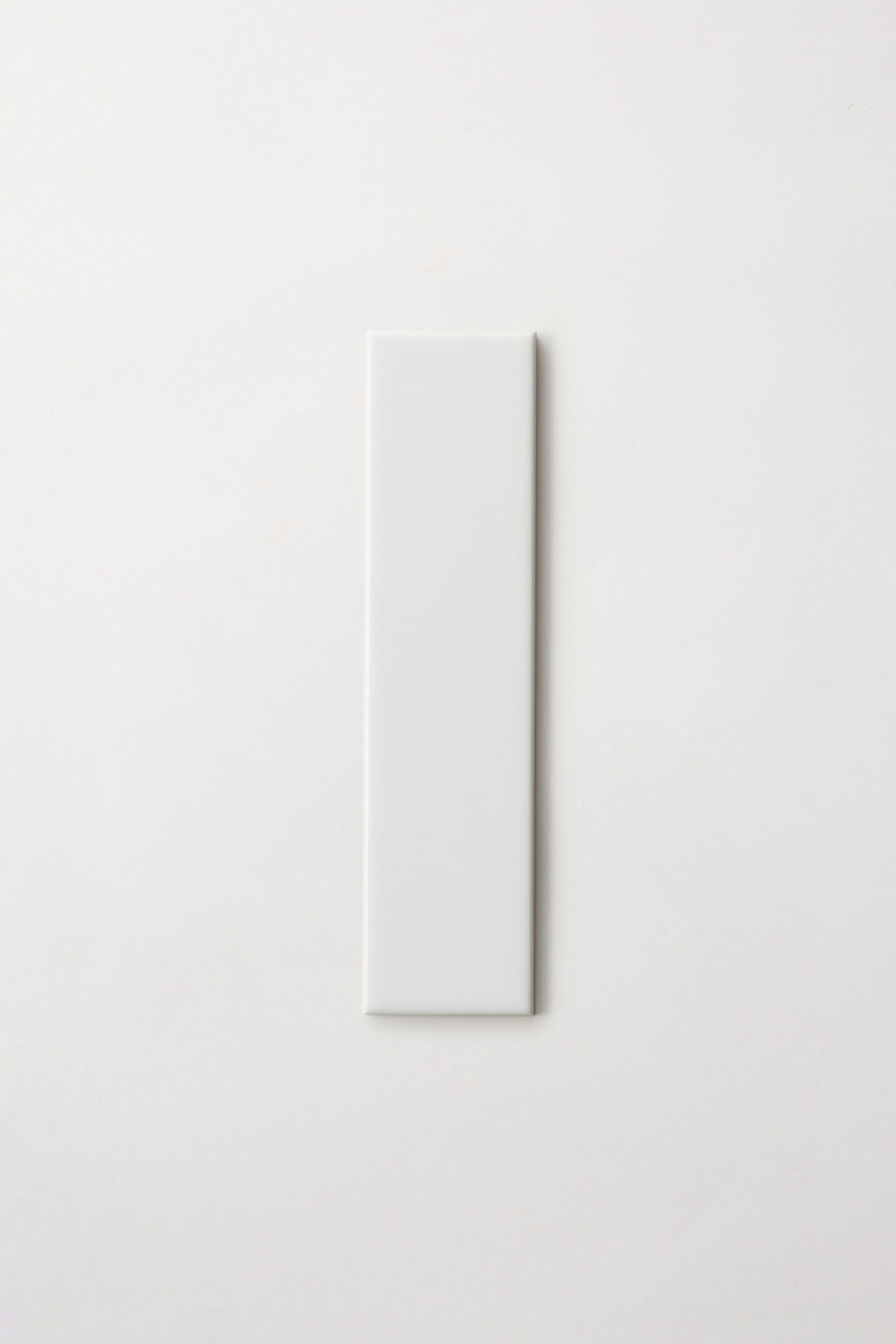 a white rectangle tile on a white background.