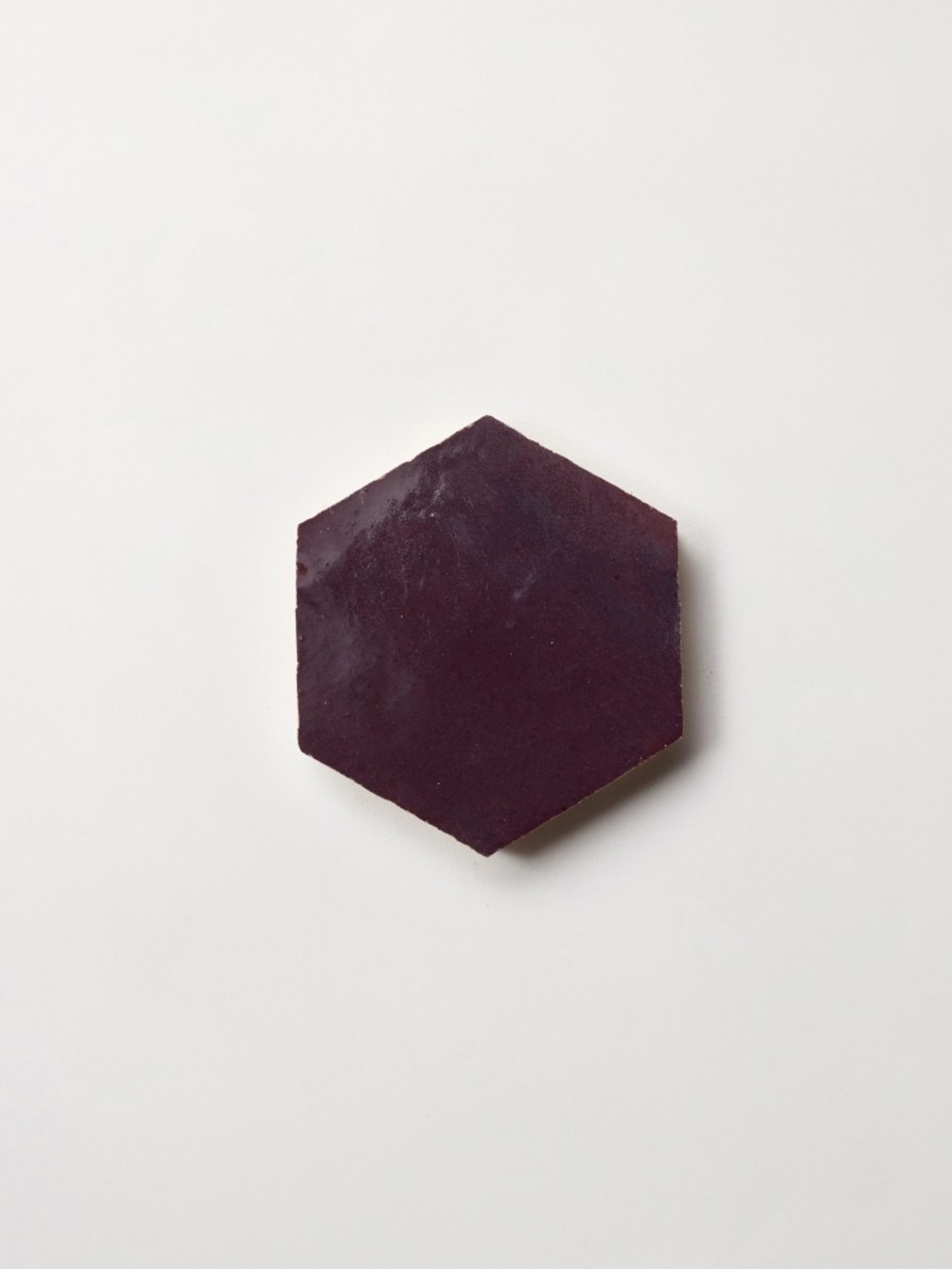 a purple hexagonal tile on a white surface.