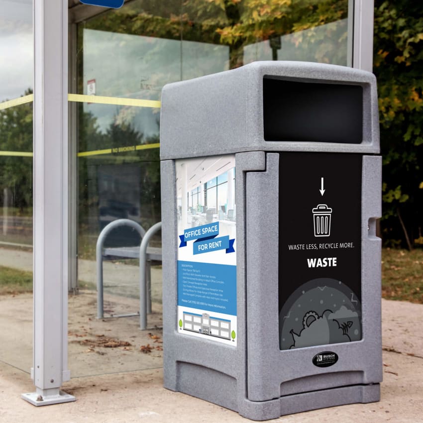 single outdoor greystone plastic trash bin with large advertisement sign sitting at a municipal transit shelter