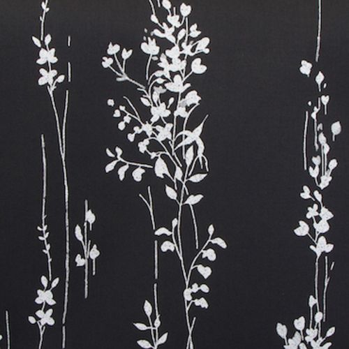 Vertical white floral-vine pattern printed in thin sketch-like lines on matte black fabric or wallpaper, close-up view showing a high-contrast, minimalist decorative surface.