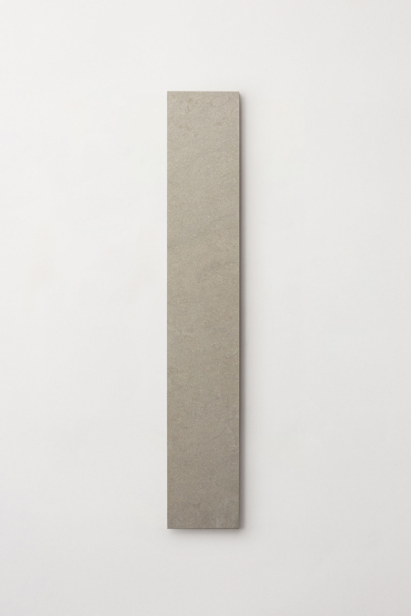 a long rectangular grey limestone tile on a white background.