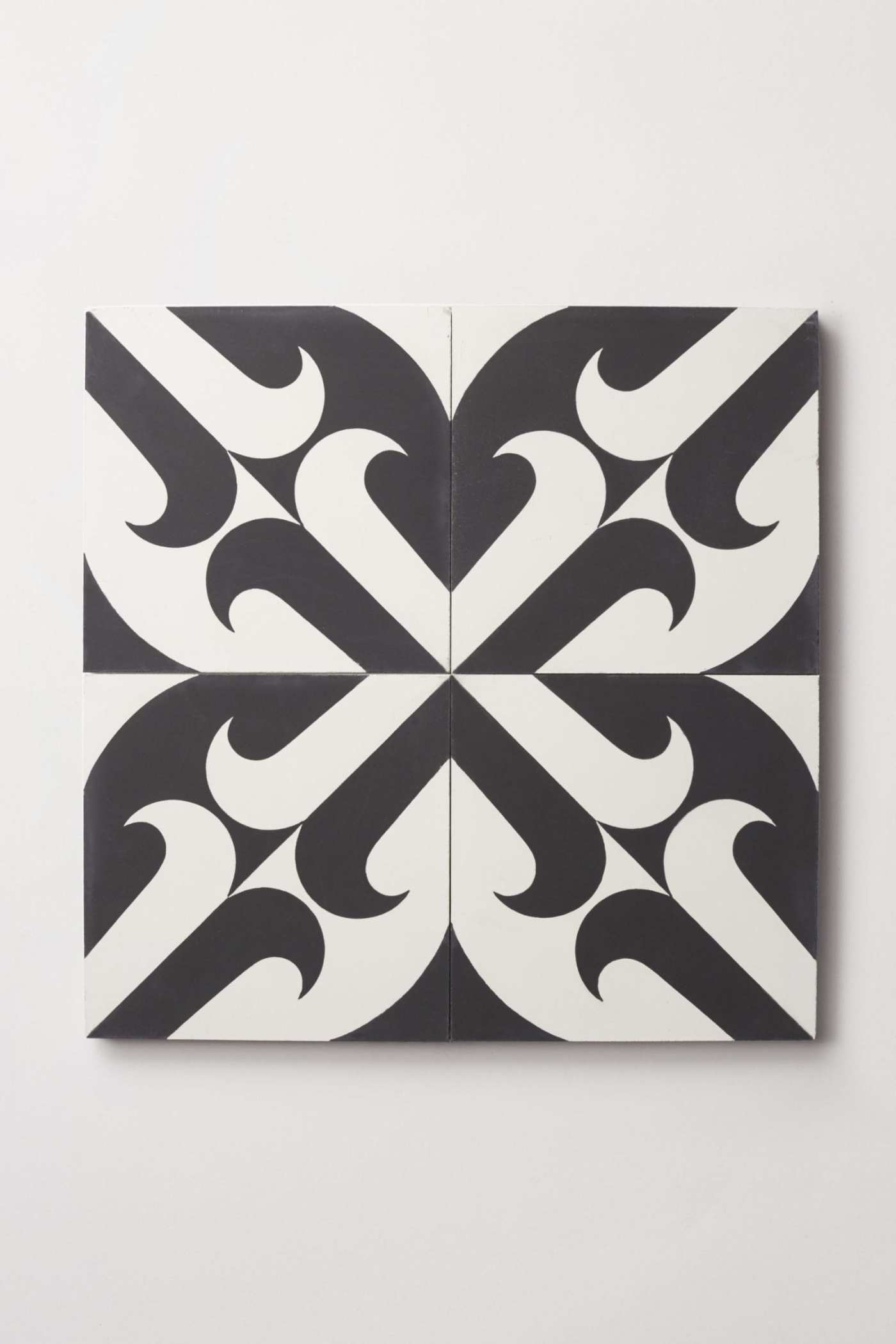 four black and white tiles on a white surface.