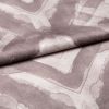 Soft woven fabric with faded mauve geometric frames and subtle heart motif (folded across the center), draped and overlapped to reveal stitched texture, close-up under even studio lighting.