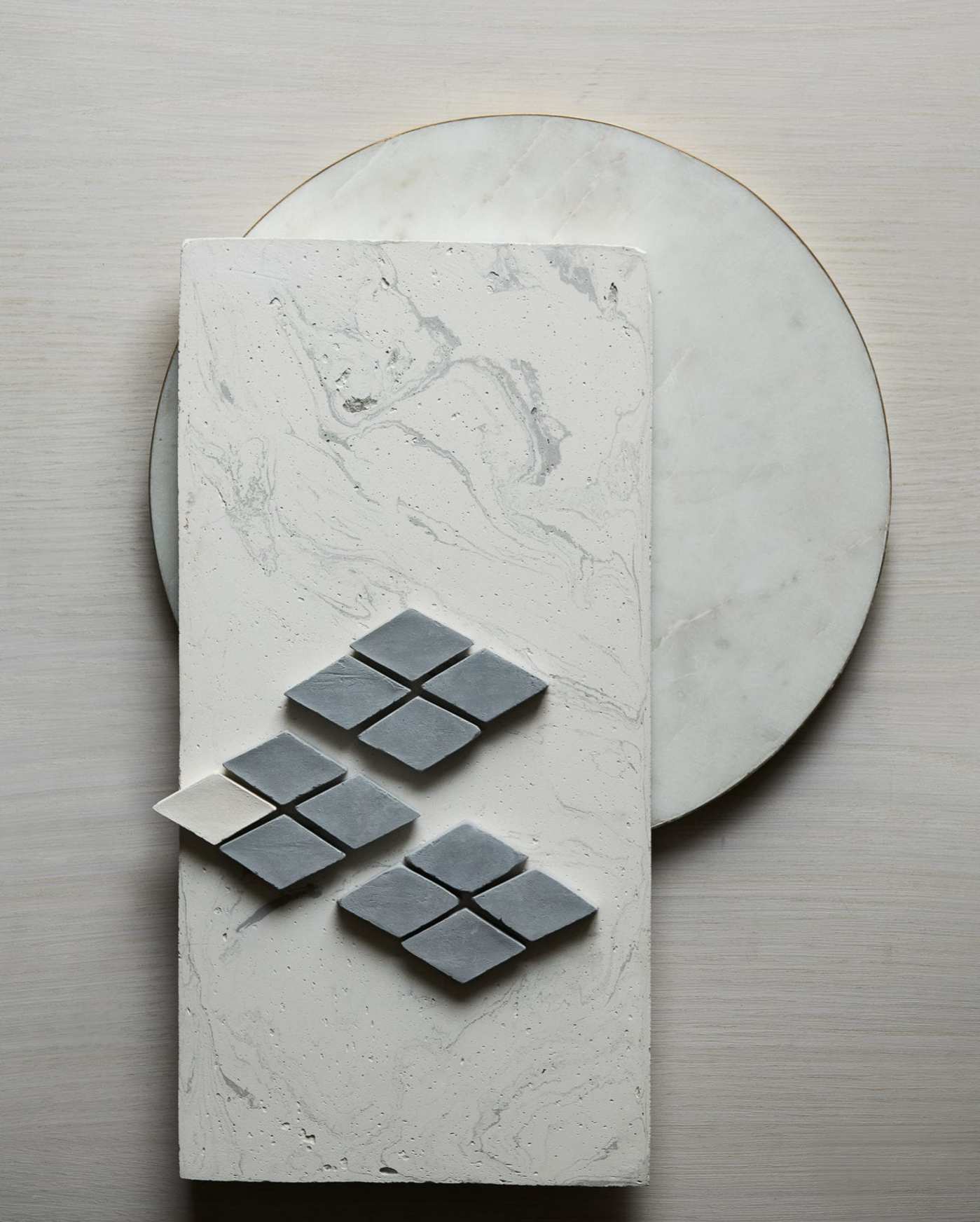 a set of various grey and marble tiles on a white surface.