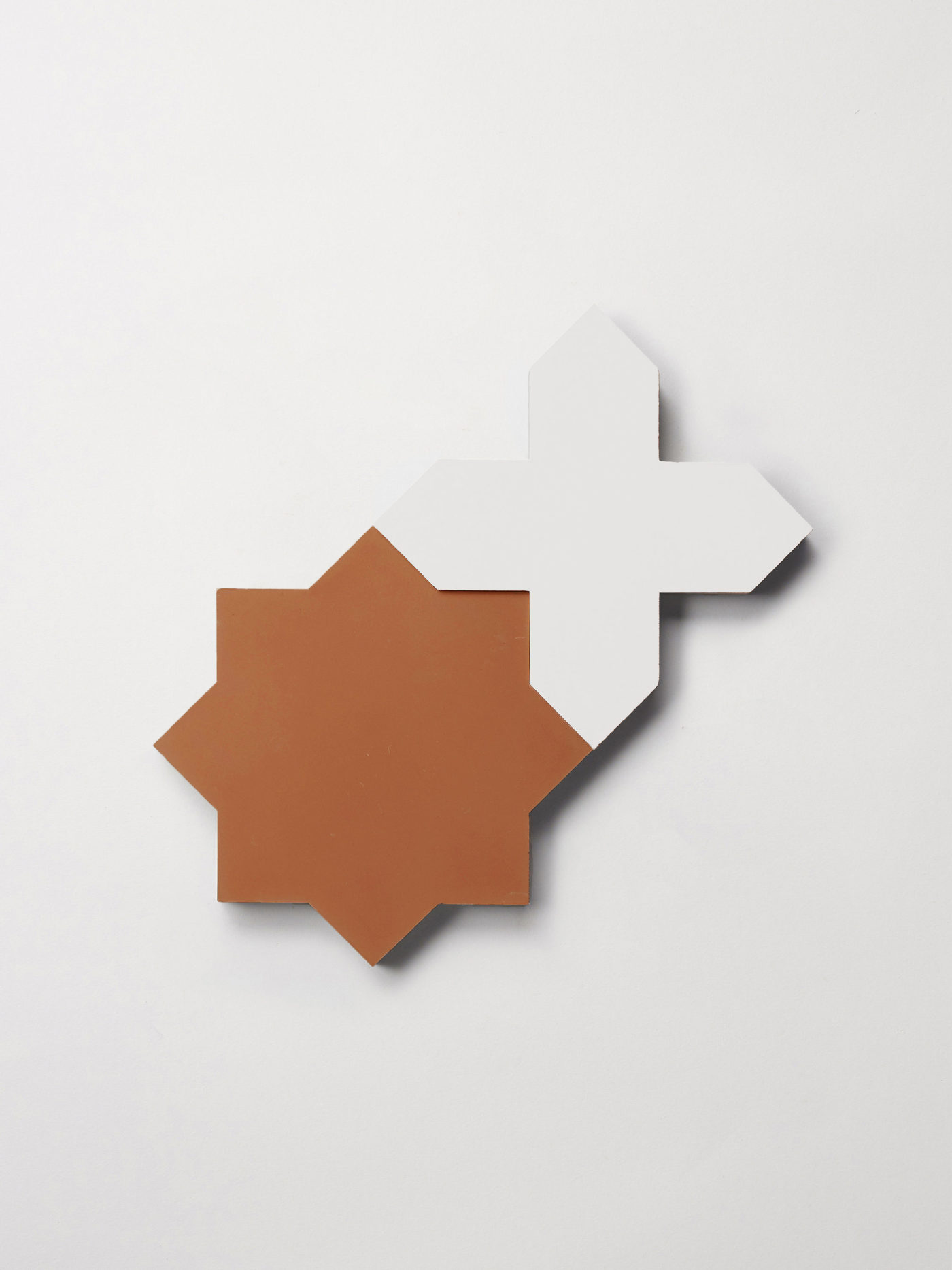 a red star and white cross tile on a white background.