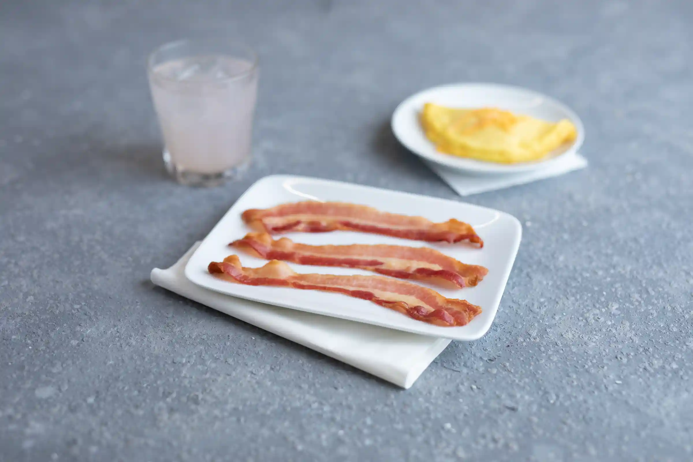 Wright® Brand Naturally Applewood Smoked Thin Sliced Bacon, Flat-Pack®, 15 Lbs, 18-22 Slices per Pound, Gas Flushedhttps://images.salsify.com/image/upload/s--3qkgypFG--/q_25/xpo663i7oztjtkwuumox.webp