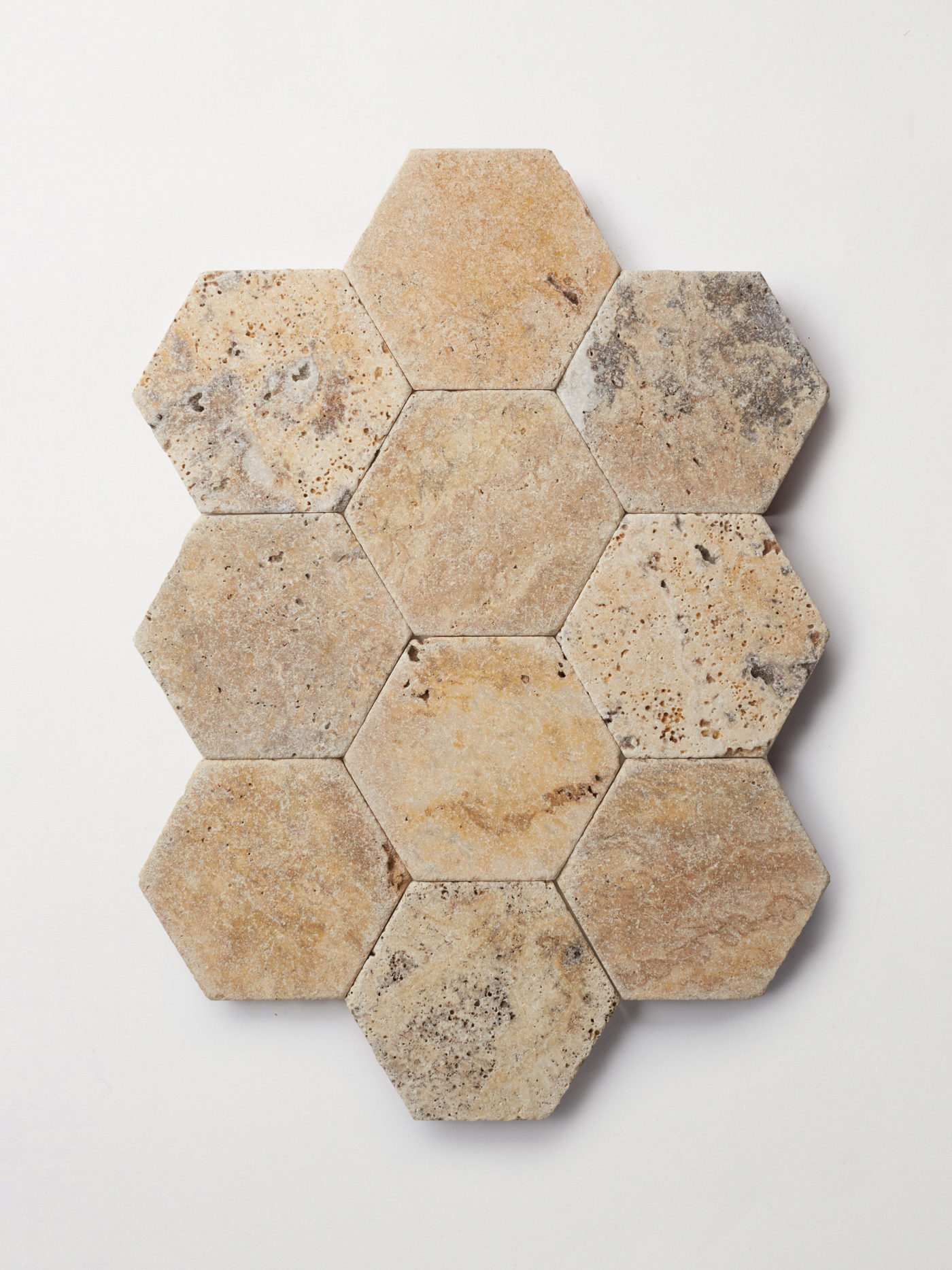 travertine hexagon mosaic tile on a white surface.