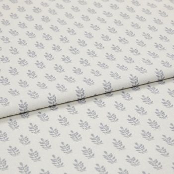 Light-coloured cotton fabric with repeating small grey leaf motifs, folded across the middle, shown in a soft, evenly lit studio close-up.
