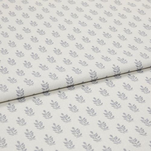 Light-coloured cotton fabric with repeating small grey leaf motifs, folded across the middle, shown in a soft, evenly lit studio close-up.