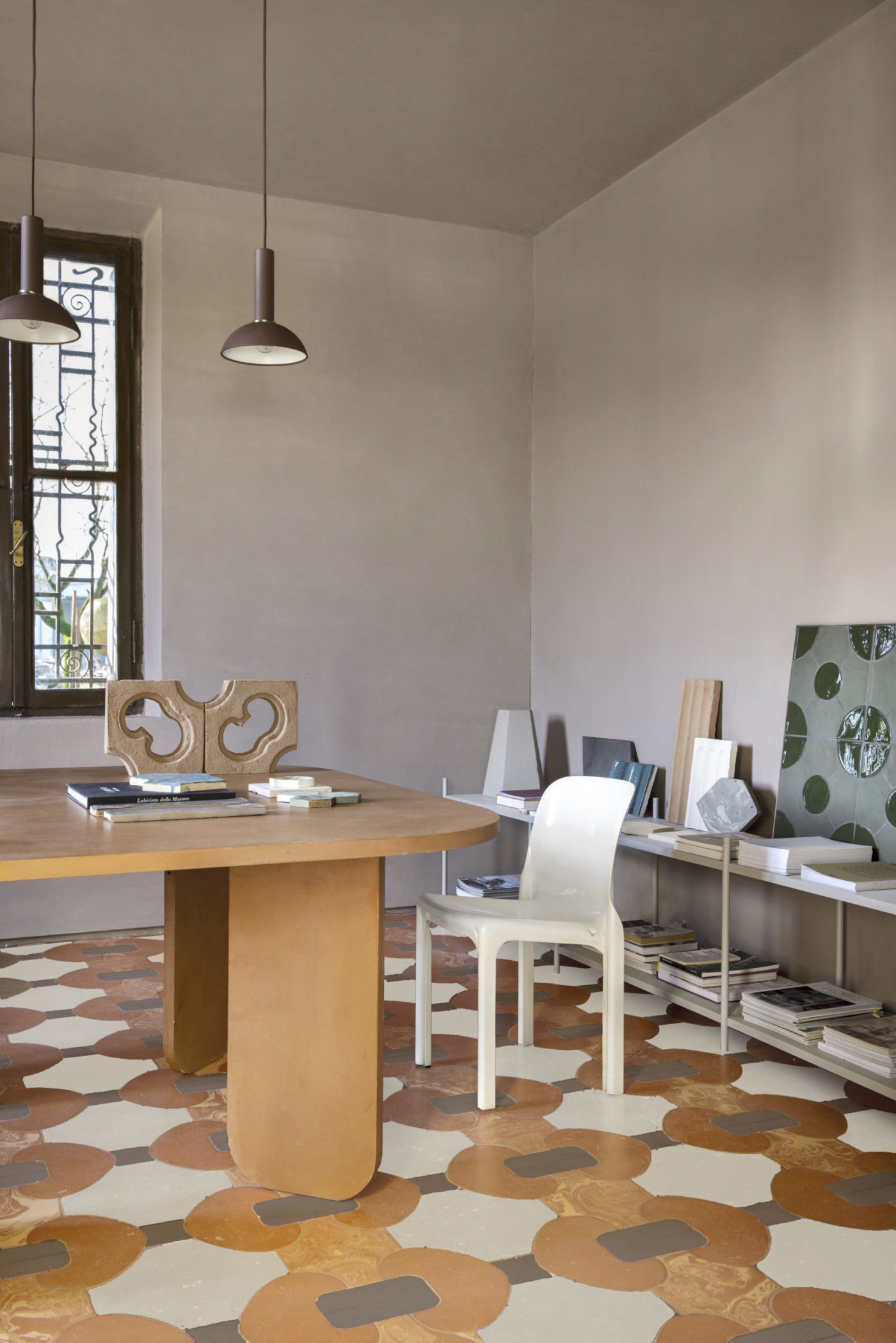 a room with a table and chairs and a tiled floor.