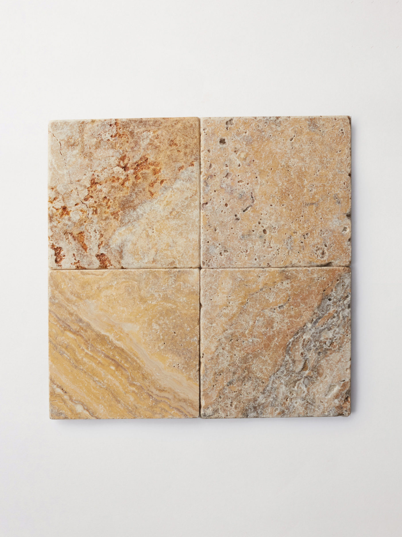 4 square natural stone tiles on a white surface.