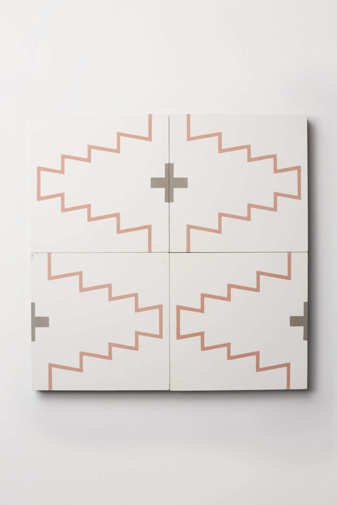 four white tiles with red patterns on them.