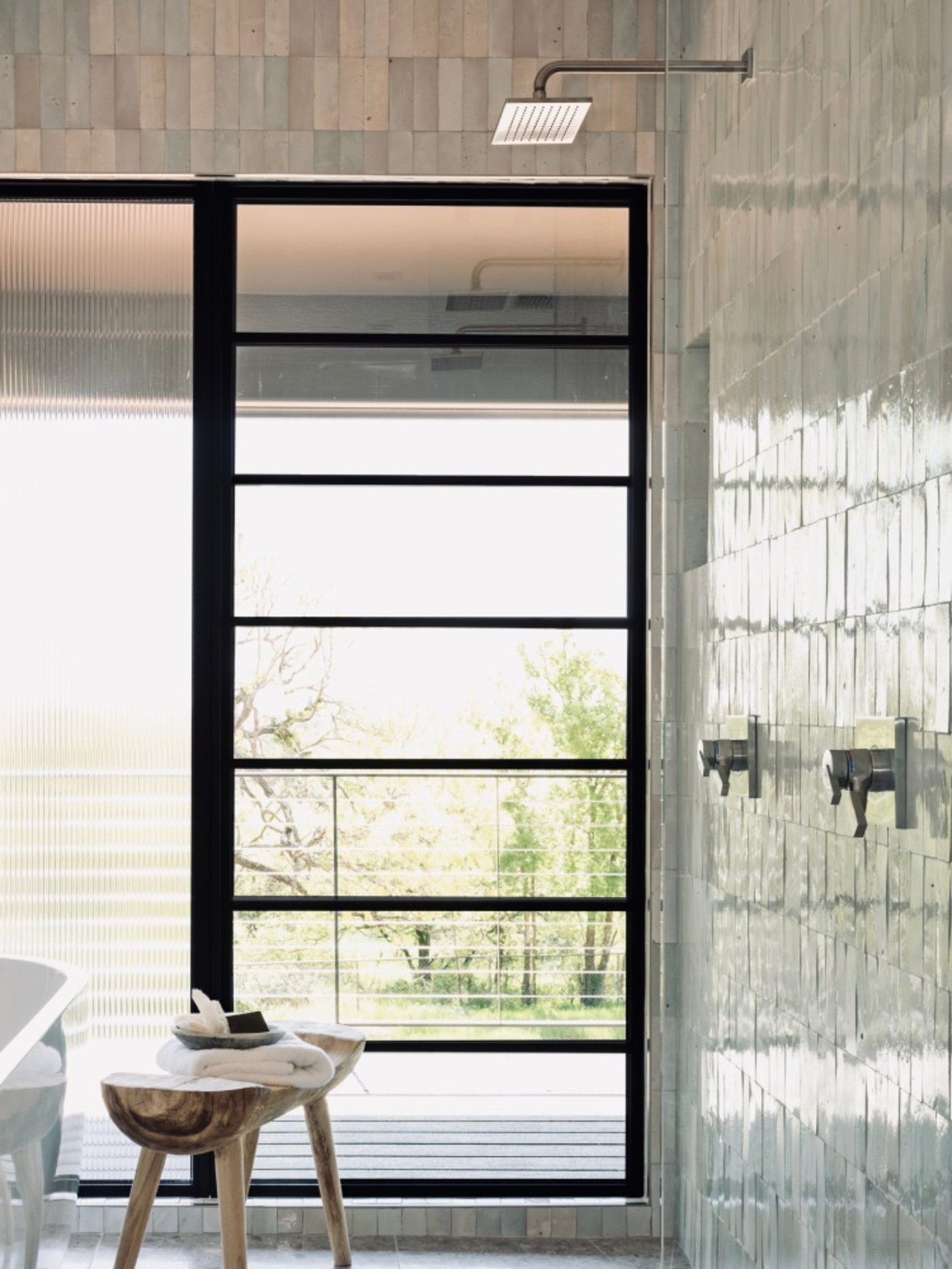 a modern bathroom with a glass shower door.