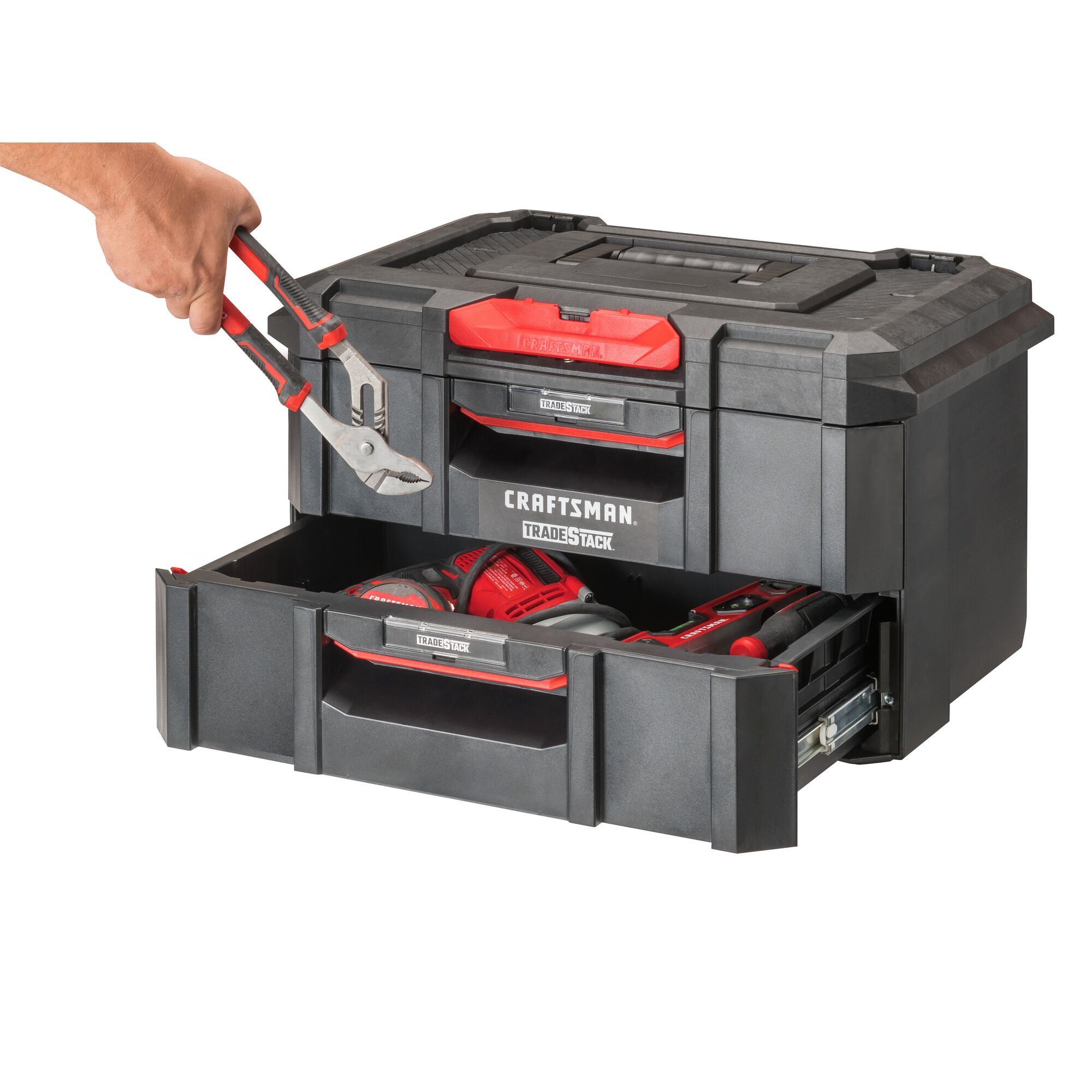 CRAFTSMAN TRADESTACK 2-Drawer Unit at three-quarter turn with hand placing CRAFTSMAN adjustable pliers into opened bottom drawer