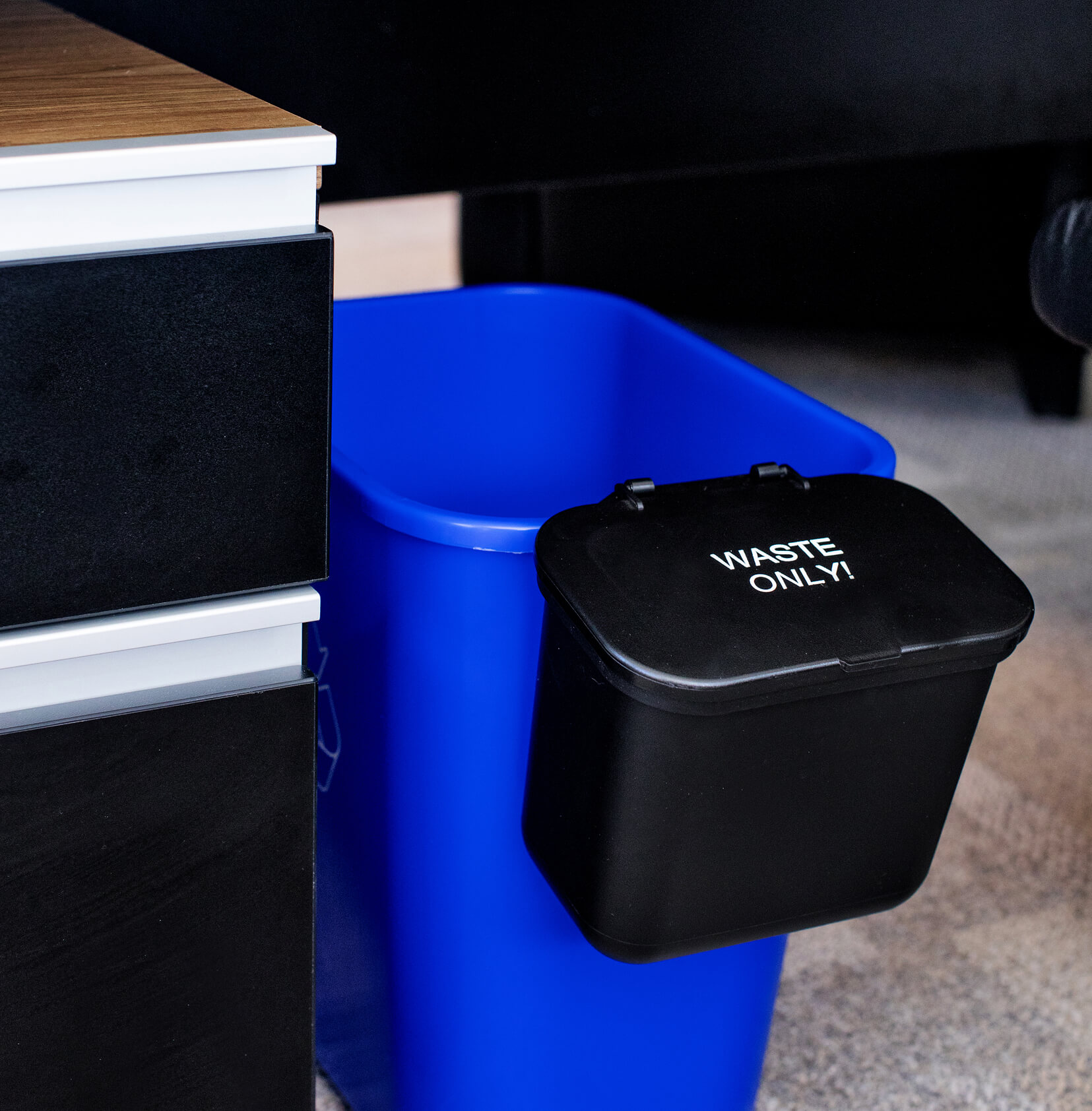 hanging waste basket for the side of a recycling container with waste only on the hinged lid for office waste collection