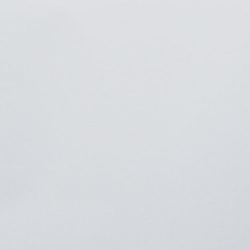 Plain pale-gray wall occupying the frame, unadorned and uniformly lit, showing subtle fabric-like texture; minimal context with soft diffuse light and no visible furnishings or details.