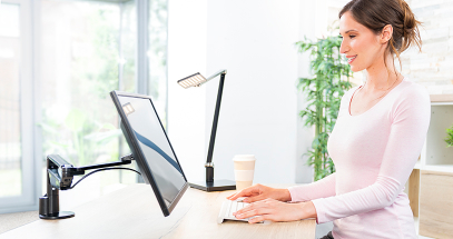 Lift a monitor off the desk surface to maximize space.