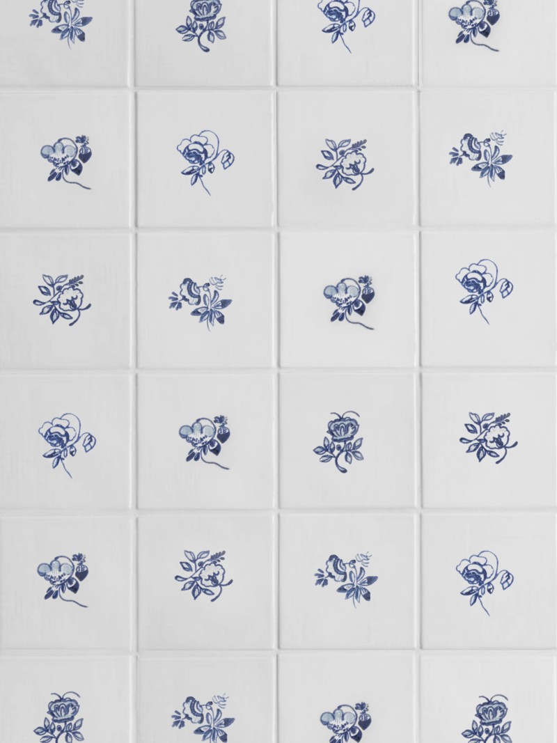 blue and white tiles with hand painted floral designs.