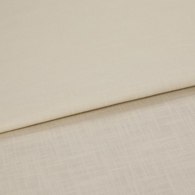Beige woven fabric panels folded over one another, overlapping to reveal two subtle textures; shown in a close-up with even, neutral lighting on a flat surface.