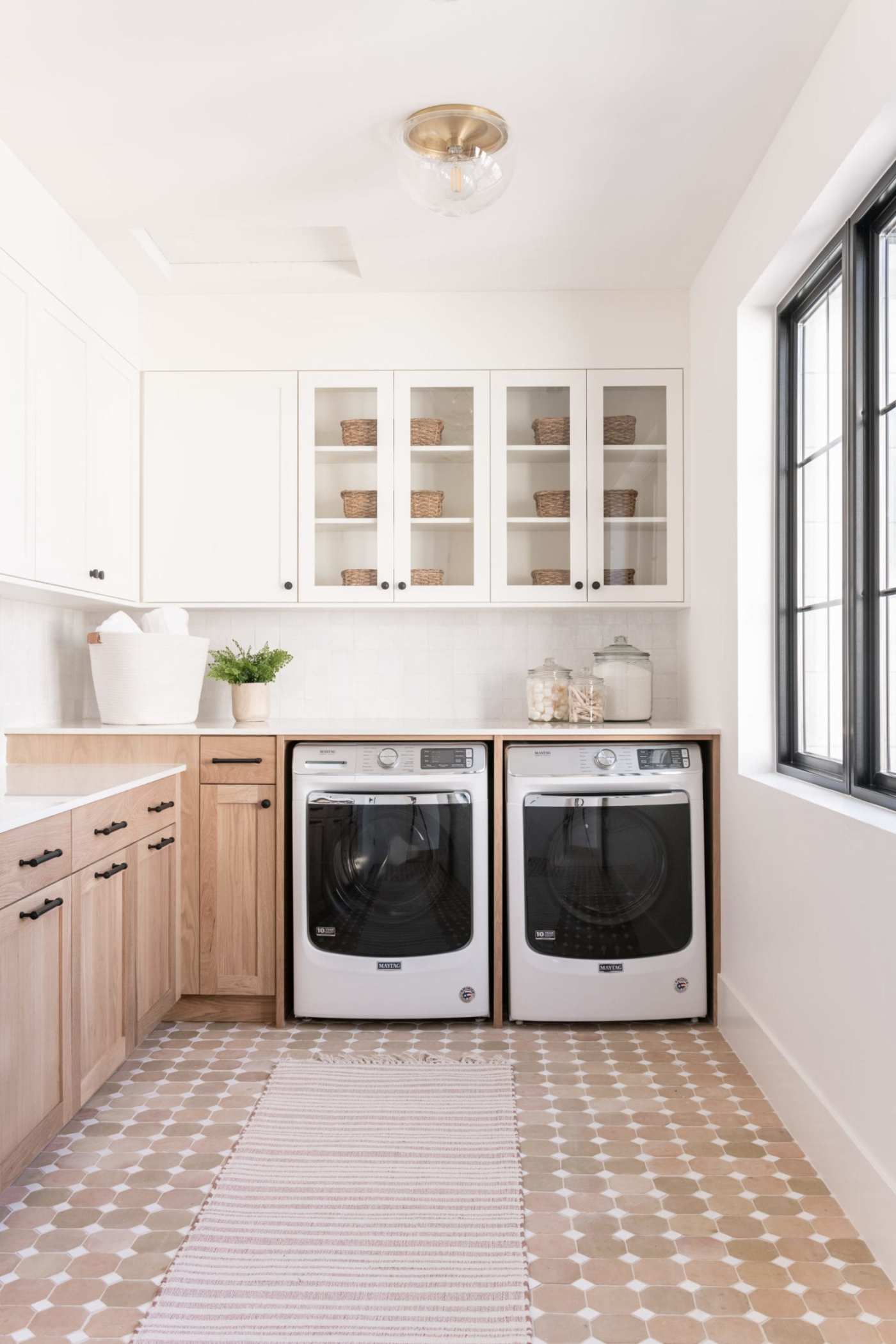 a white and beige laundry room with a washer and dryer.