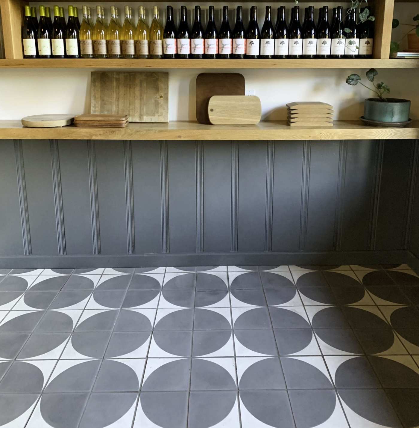 a grey and white tiled floor in a wine bar.