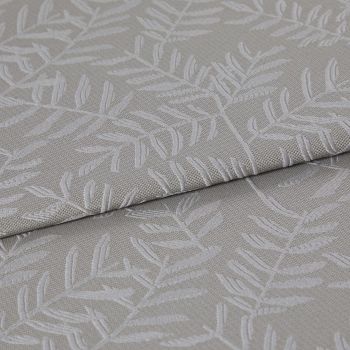 Beige-gray woven fabric with raised white botanical leaf pattern, folded once and layered, displaying texture and subtle sheen; close-up on textile surface under soft, neutral lighting.