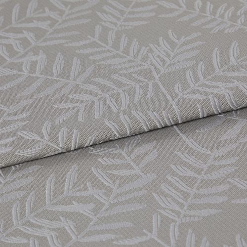 Beige-gray woven fabric with raised white botanical leaf pattern, folded once and layered, displaying texture and subtle sheen; close-up on textile surface under soft, neutral lighting.